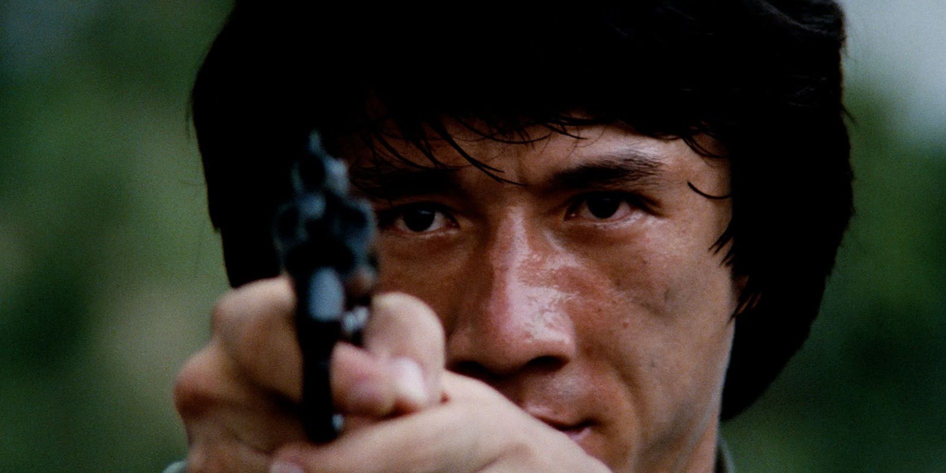 Jackie Chan holding a pistol in Police Story