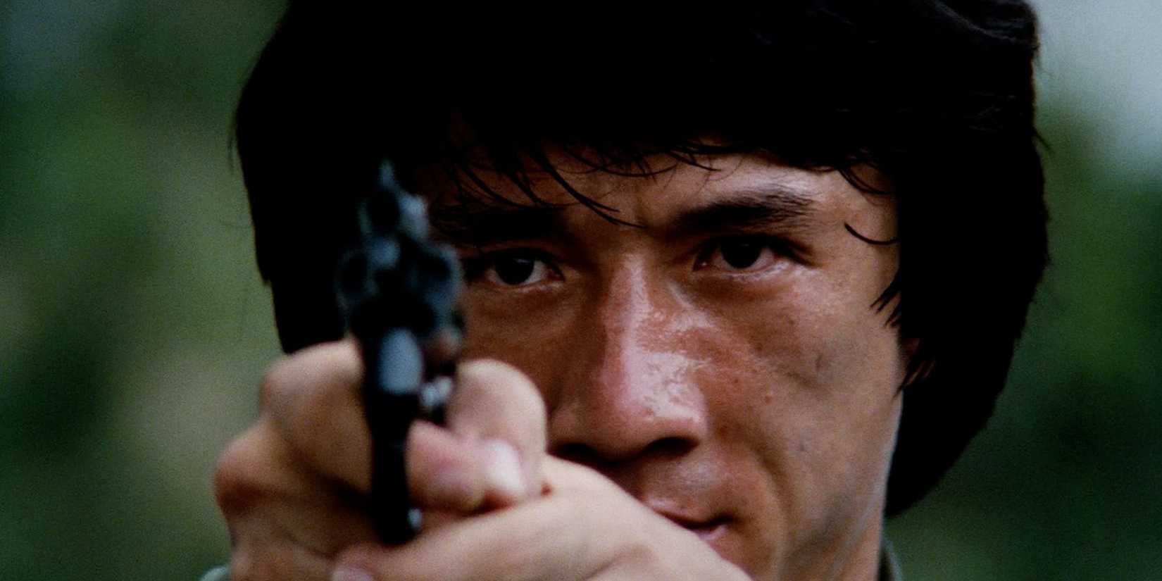 Jackie Chan holding a pistol in Police Story