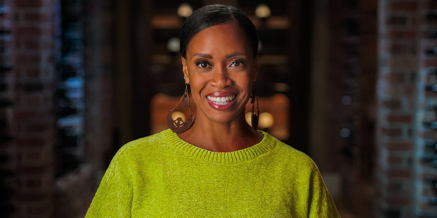 Million Dollar Secret season 1 Jaimi Alexander wearing a bright green sweater with wine racks in the background.