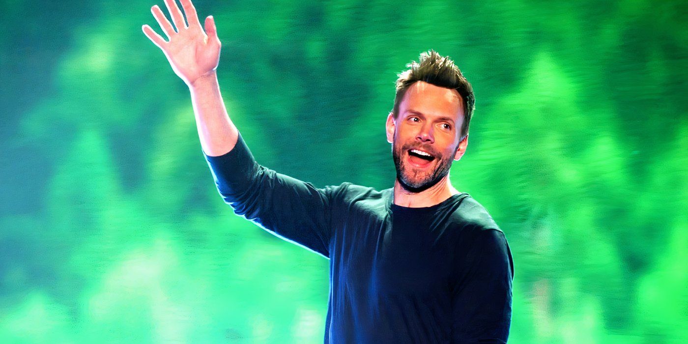 Joel McHale waving in the Live from Pyongyang comedy special