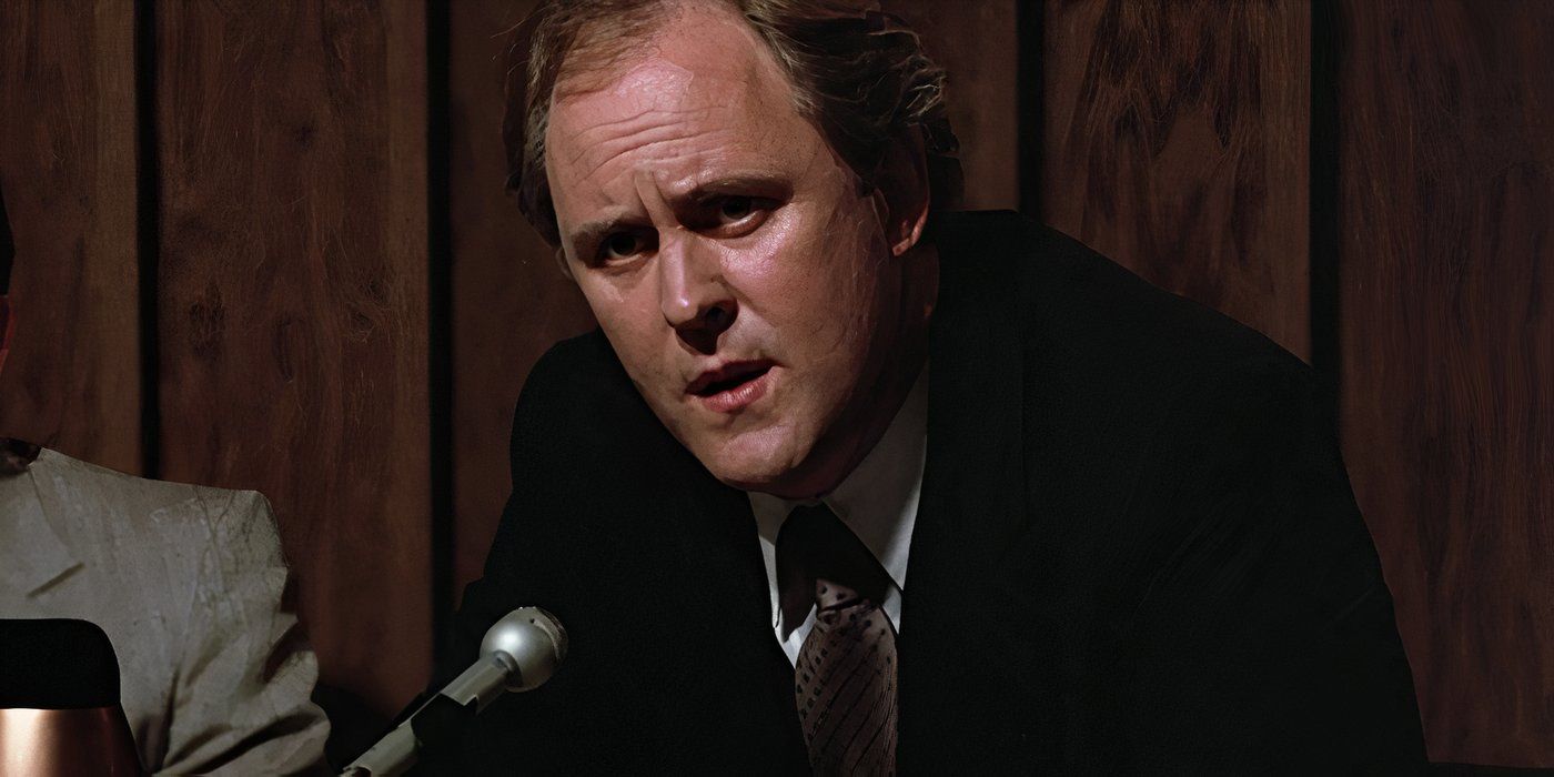 John Lithgow speaking into a microphone in Footloose