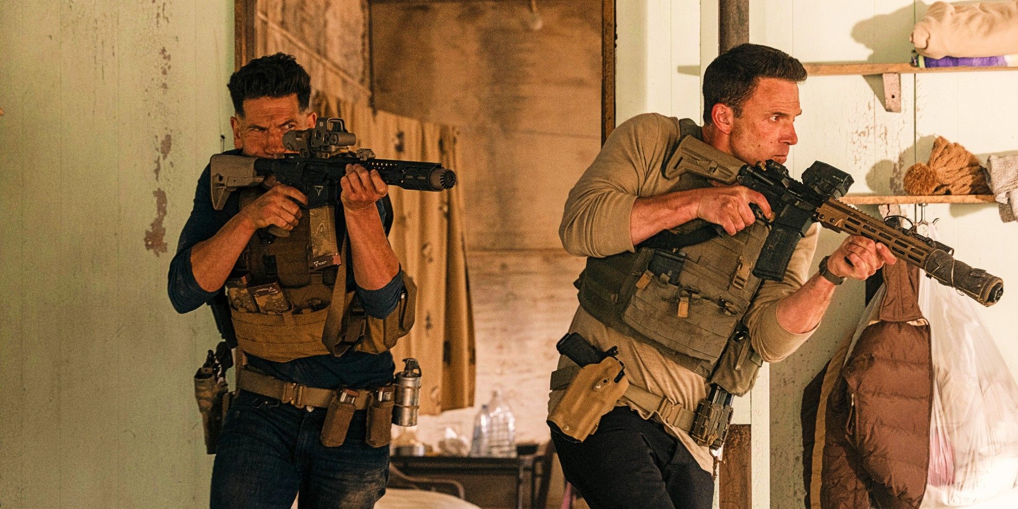 Jon Bernthal and Ben Affleck in formation carrying guns in military uniforms in The Accountant 2