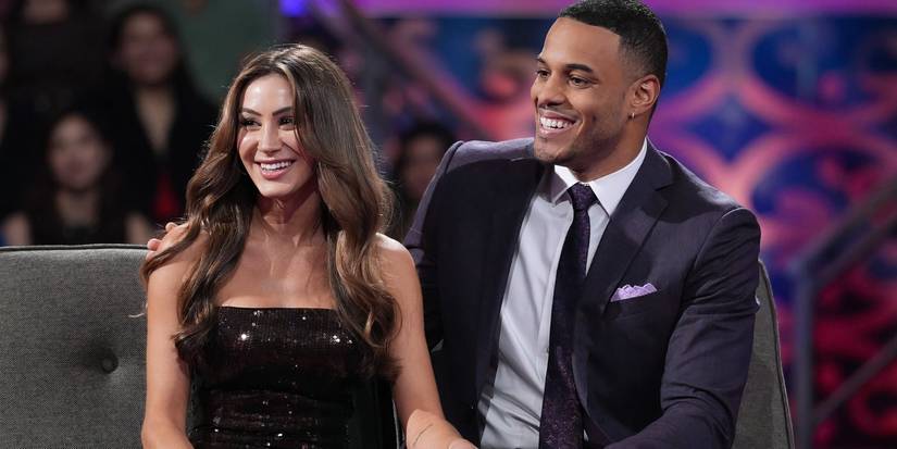 Juliana Pasquaroa and Grant Ellis sit together with wide smiles on The Bachelor