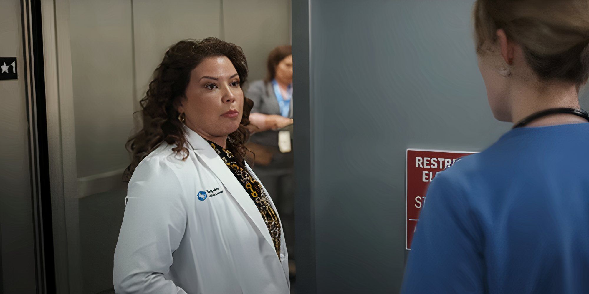 Justina Machado standing beside an elevator on Pulse