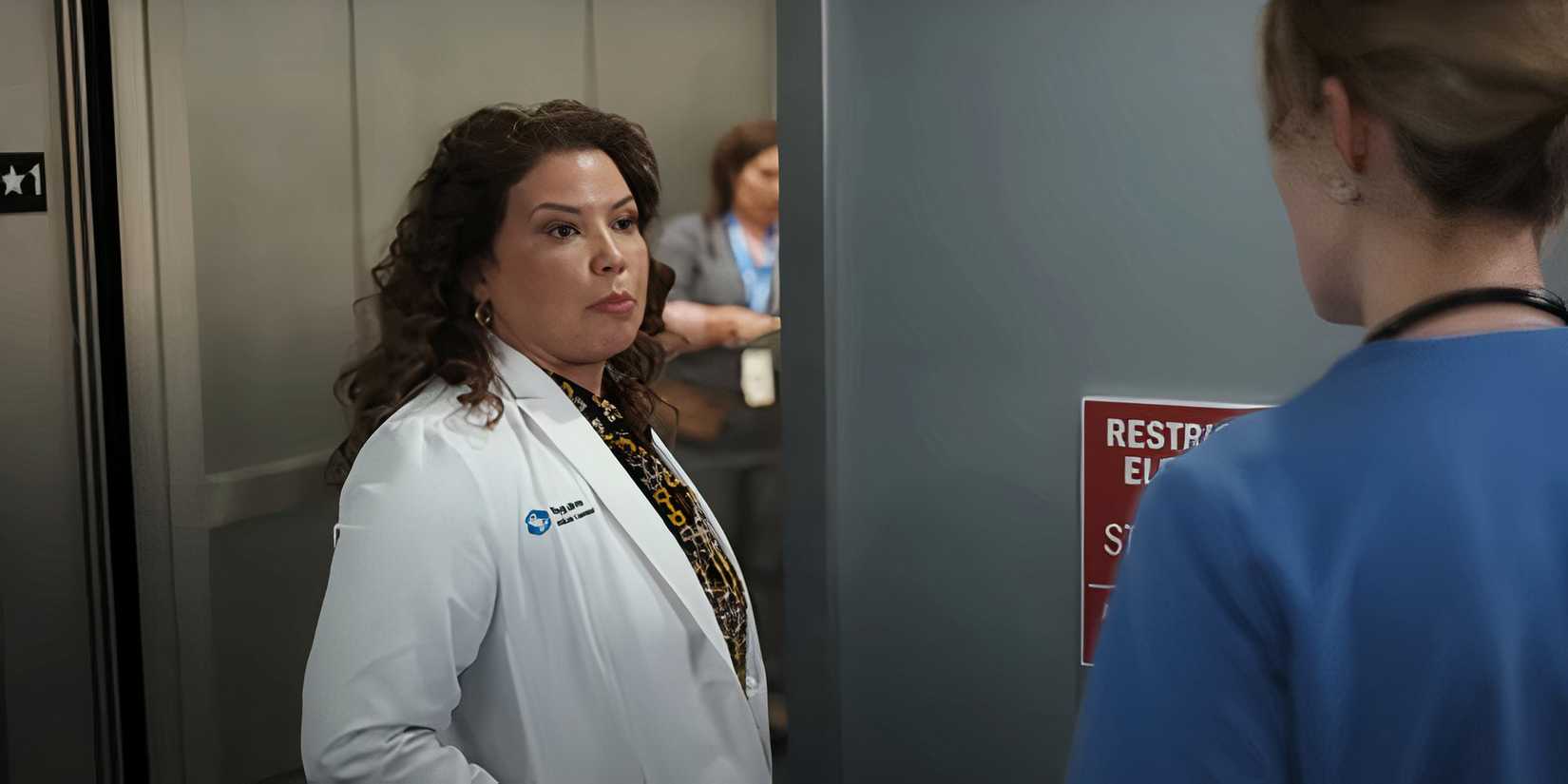 Justina Machado standing beside an elevator on Pulse