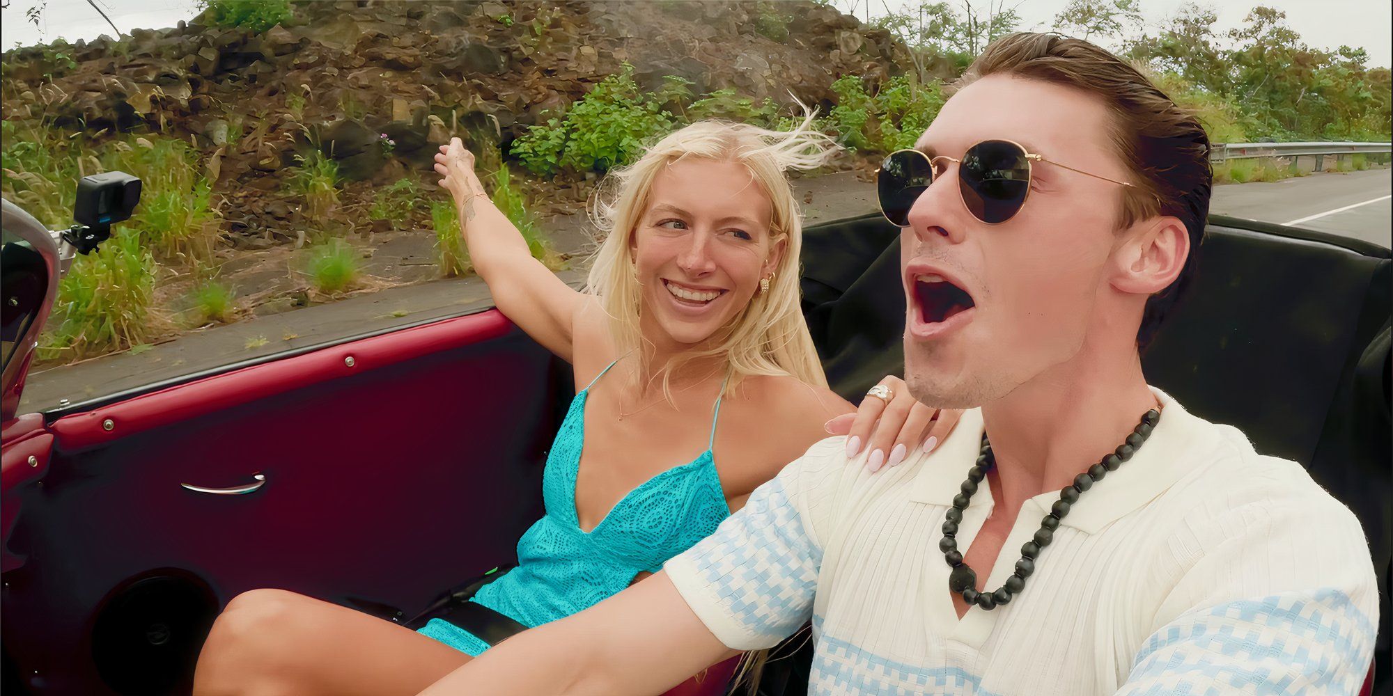 Kay and Tyler driving through Hawaii, smiling and 'wooing'