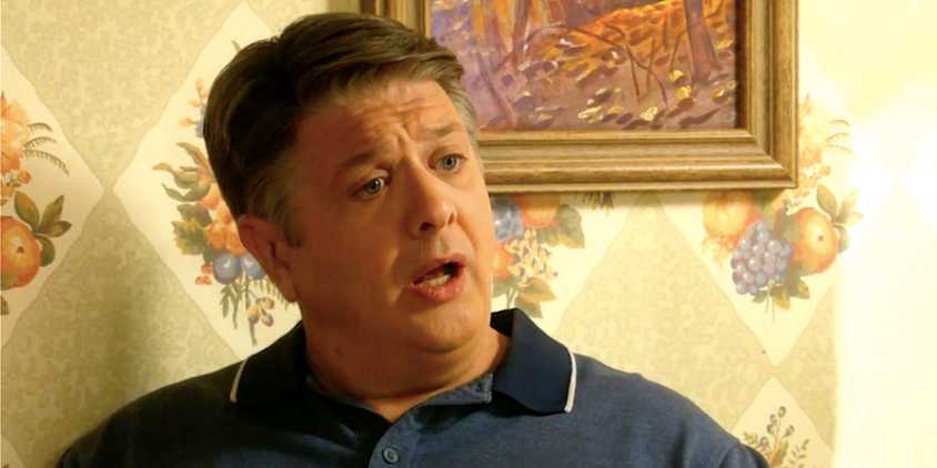 Lance Barber's George Sr looking shocked at a kitchen table in Georgie & Mandy's First Marriage