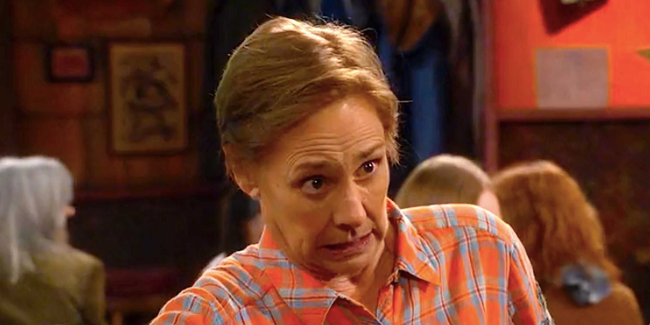 Laurie Metcalf&rsquo;s Jackie sits at a bar and looks concerned in The Conners season 7 episode 1