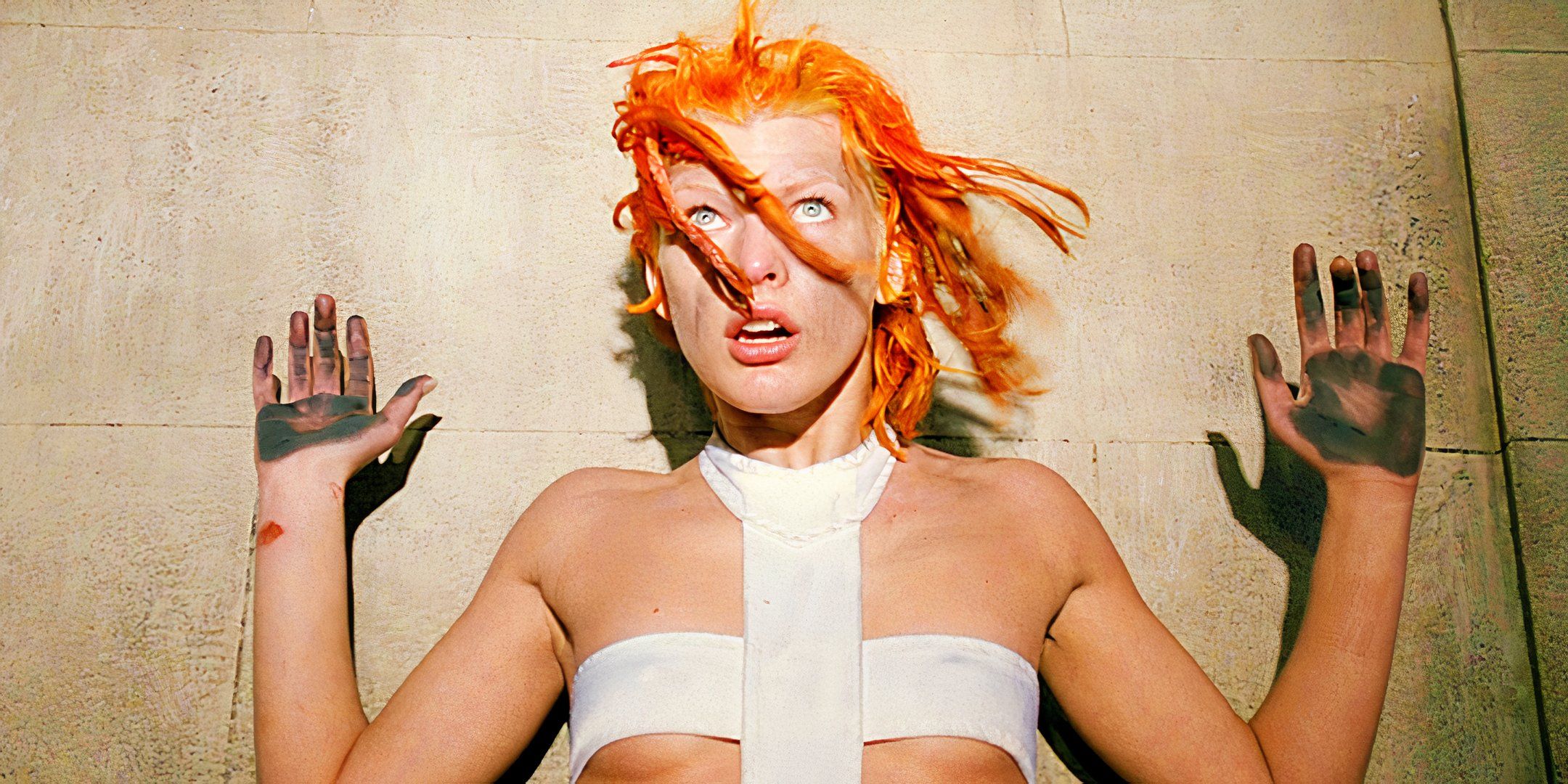 Milla Jovovich holding her hands up as Leeloo in The Fifth Element