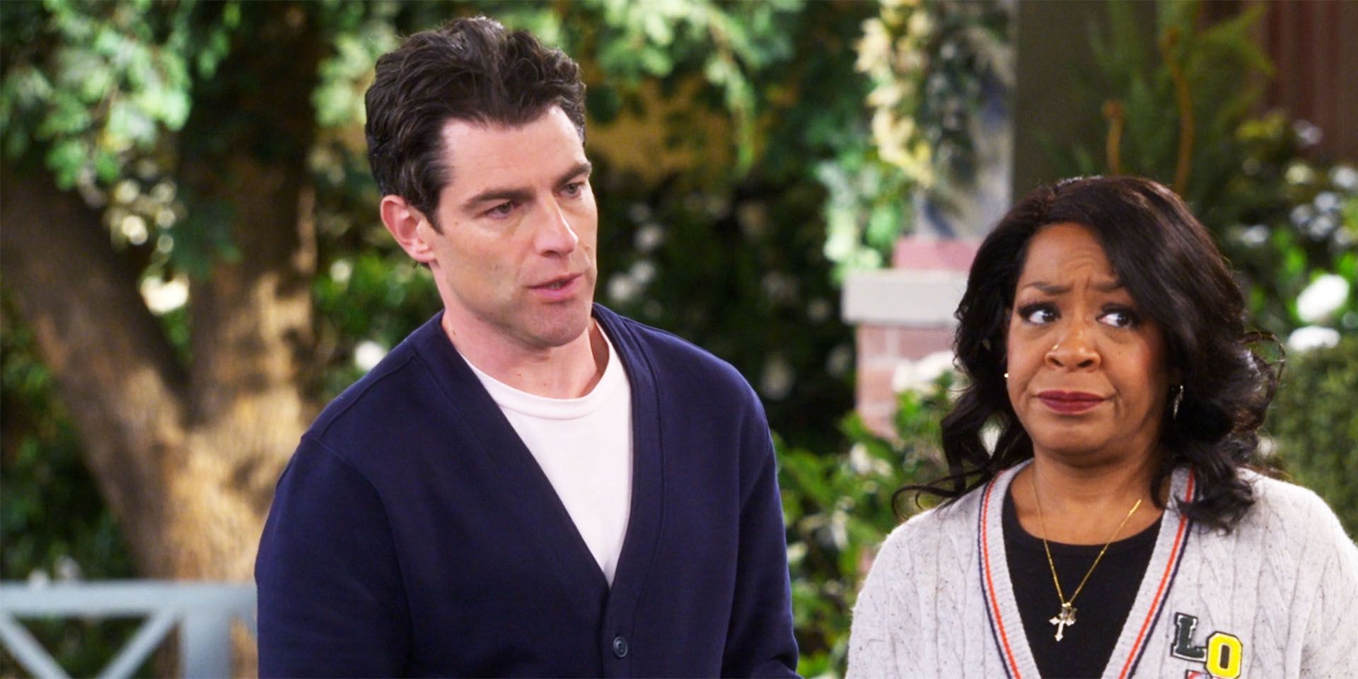 Looking concerned, Tina stands with Dave on The Neighborhood