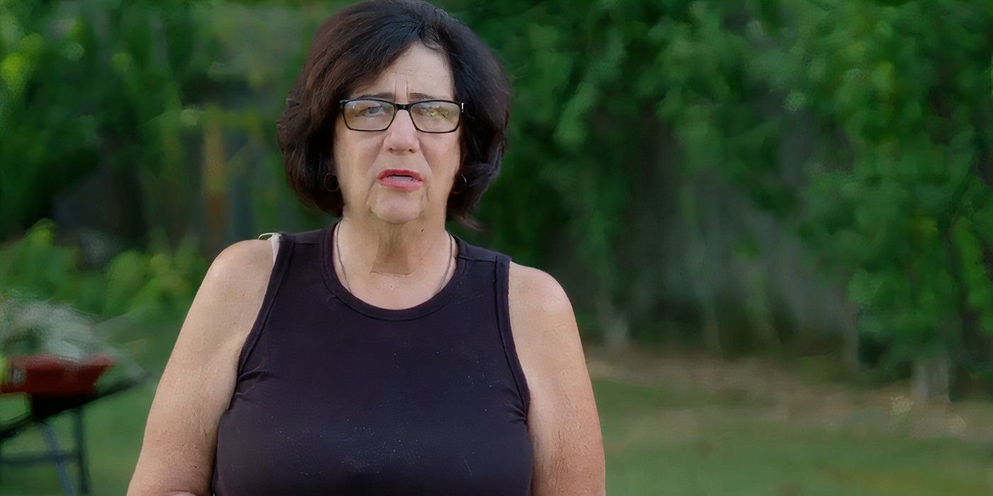 Lucille in 90 Day Fiance in black top talking outside.