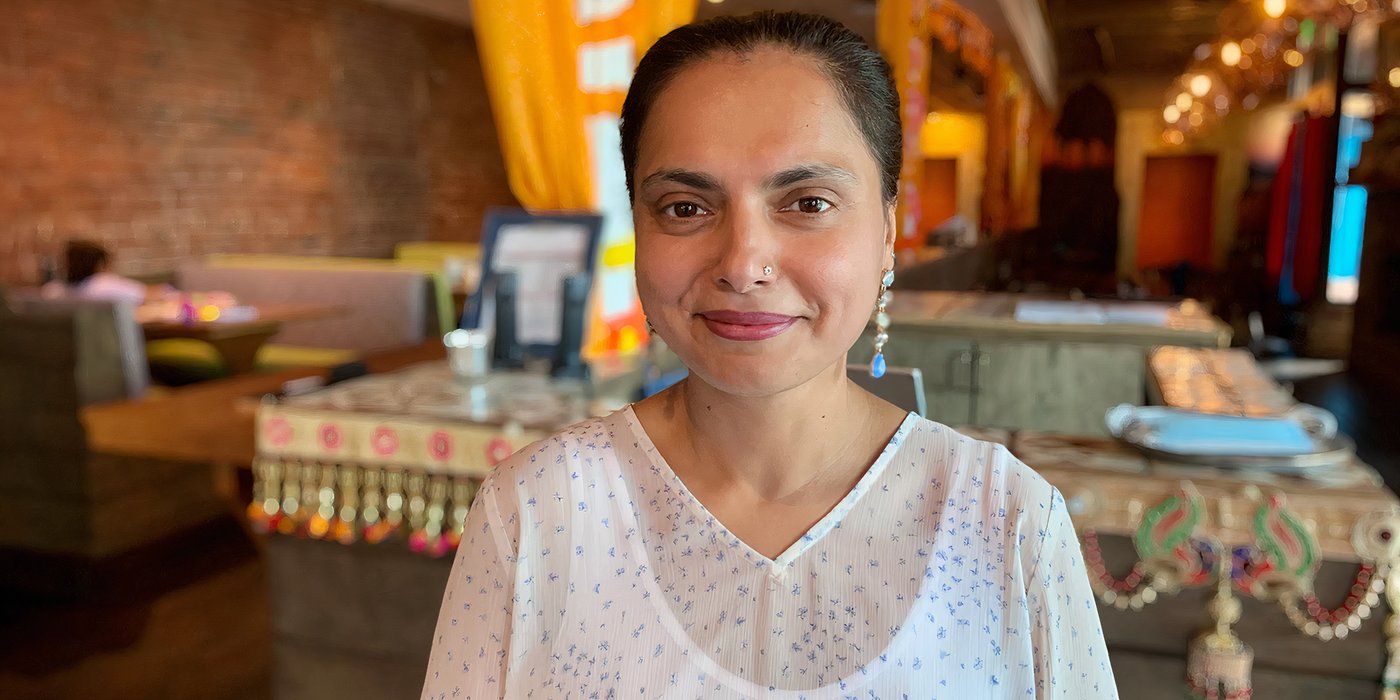Maneet Chauhan posing in a restaurant dining room