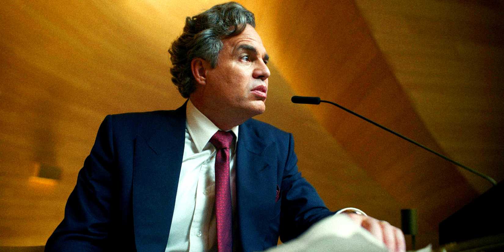 Marshall (Mark Ruffalo) at a podium shot from an angle below him in Mickey 17