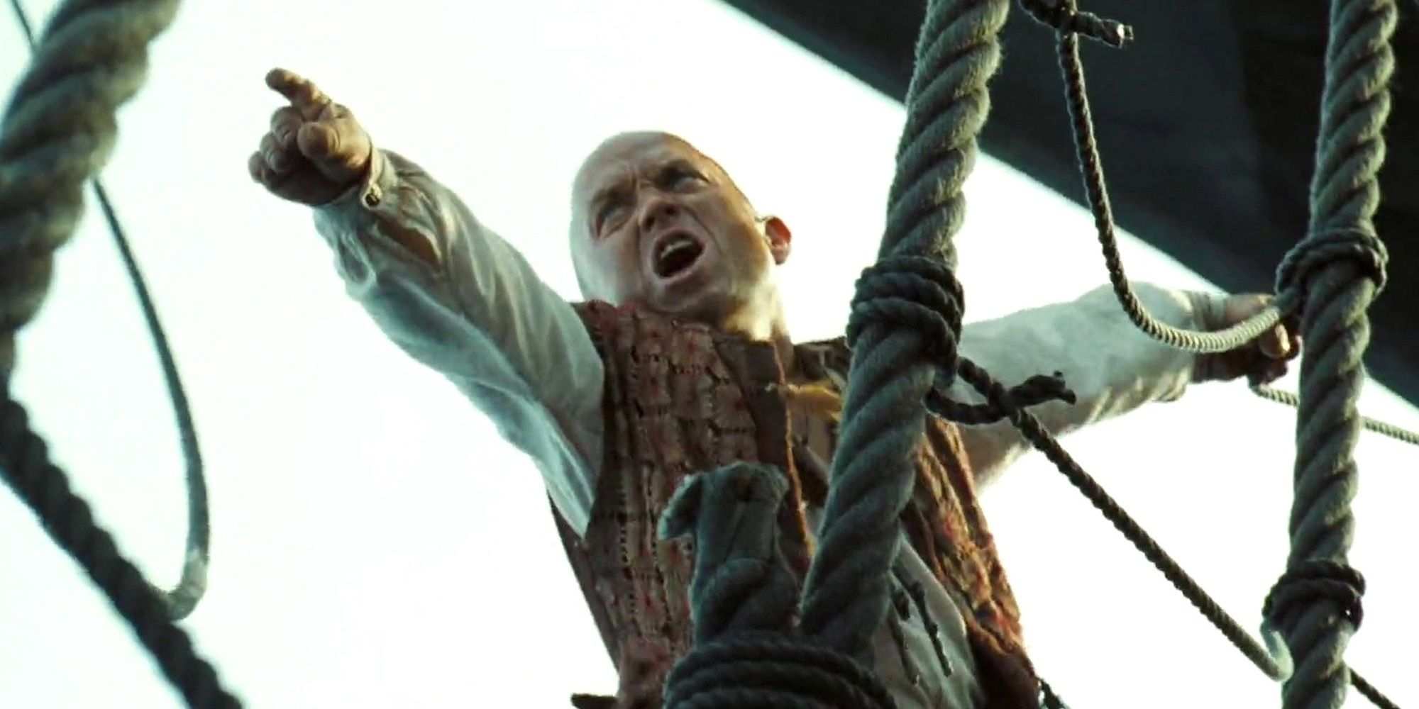 Marty (Martin Klebba) shouting and pointing to another ship in Pirates of the Caribbean Dead Man's Chest