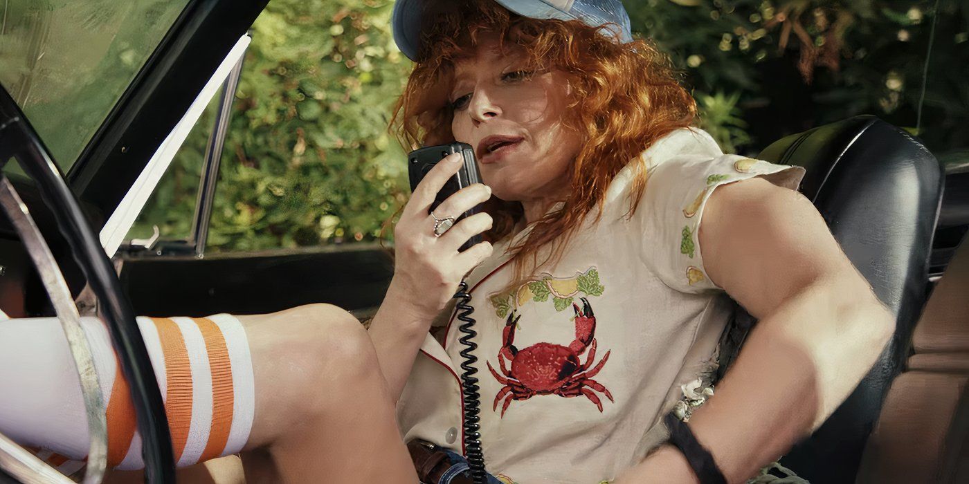 Natasha Lyonne as Charlie Cale on the radio in her car in Poker Face season 2