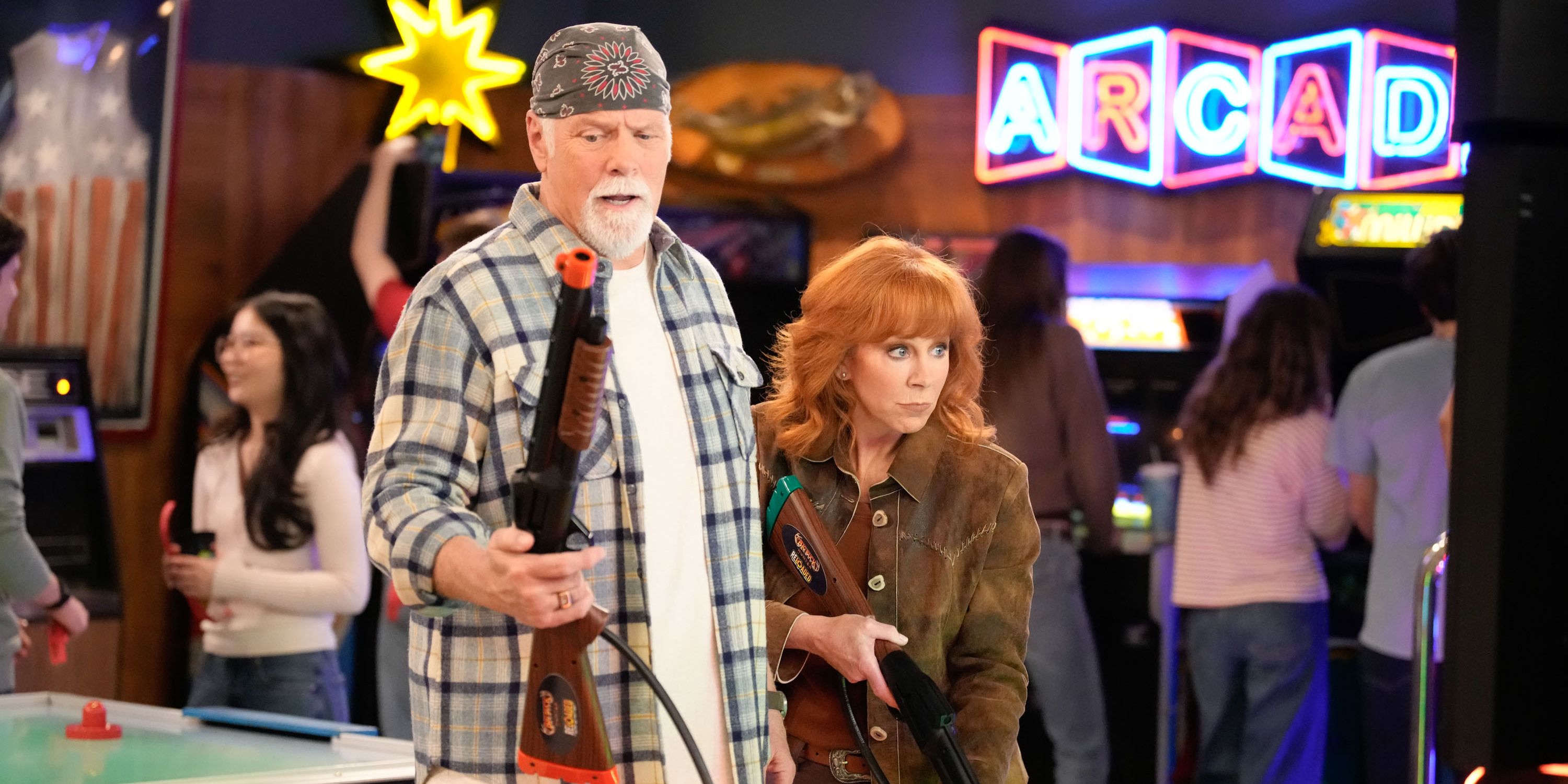 Emmett and Bobbie playing a shooting game in Happy&rsquo;s Place season 1 finale