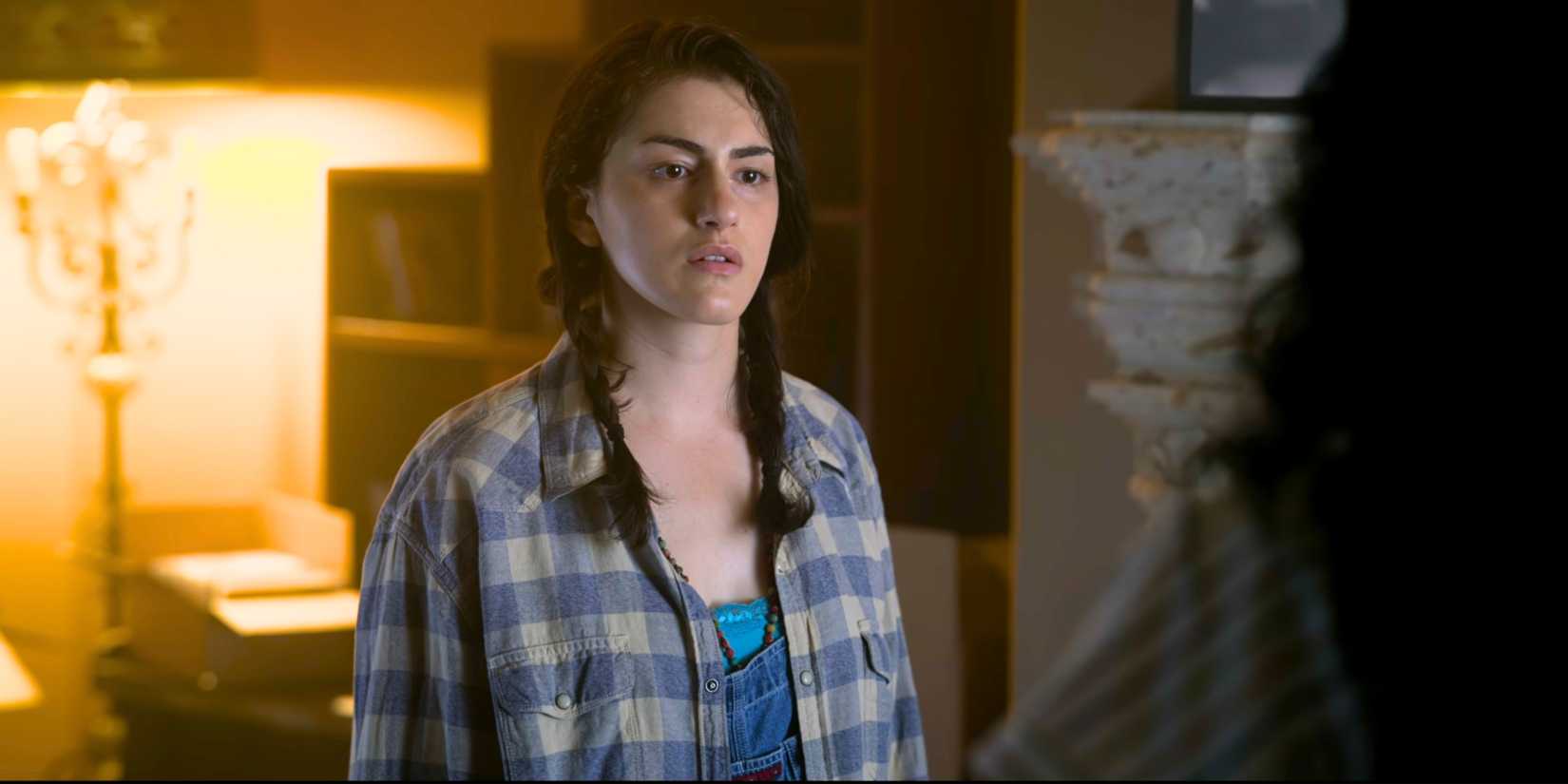 Lilli Kay as Penelope Fowler in braids and flannel shirt
