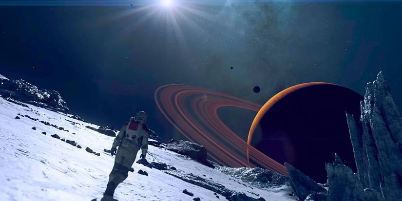 A Starfield player walking on a barren moon with a ringed planet on the horizon.