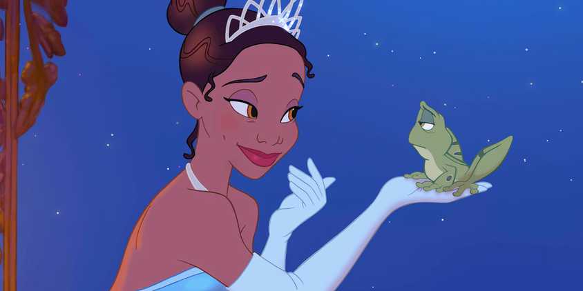 Tiana holds up a frog in The Princess and the Frog