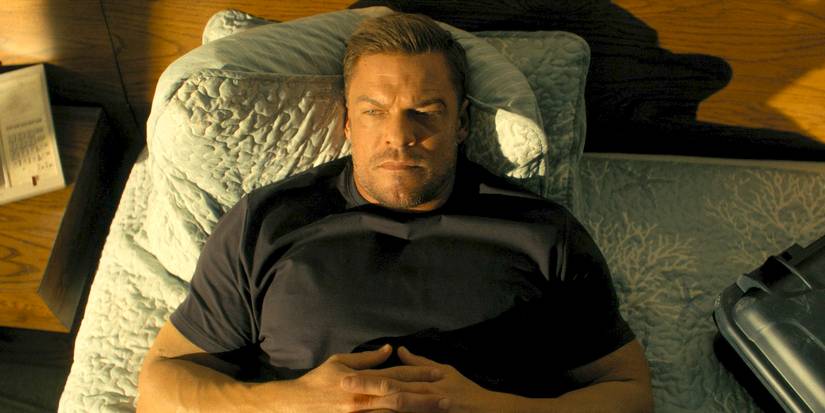 Jack Reacher (Alan Ritchson) laying on a bed looking grumpy in Reacher Season 3 Ep 7