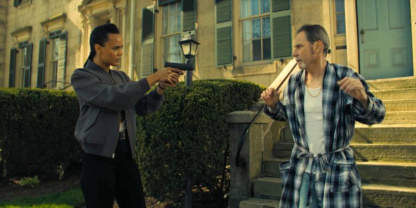 Frances Neagley (Maria Sten) pointing a gun at a man in Reacher Season 3 Ep 7