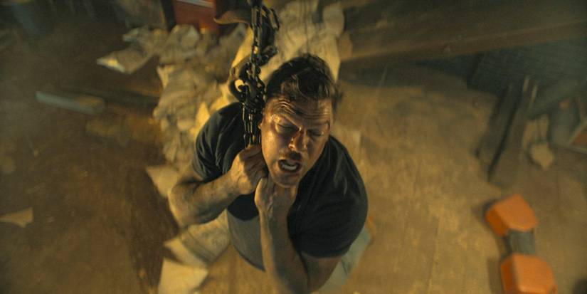 Jack Reacher (Alan Ritchson) hanging by his neck from a chain in Reacher Season 3 Ep 8