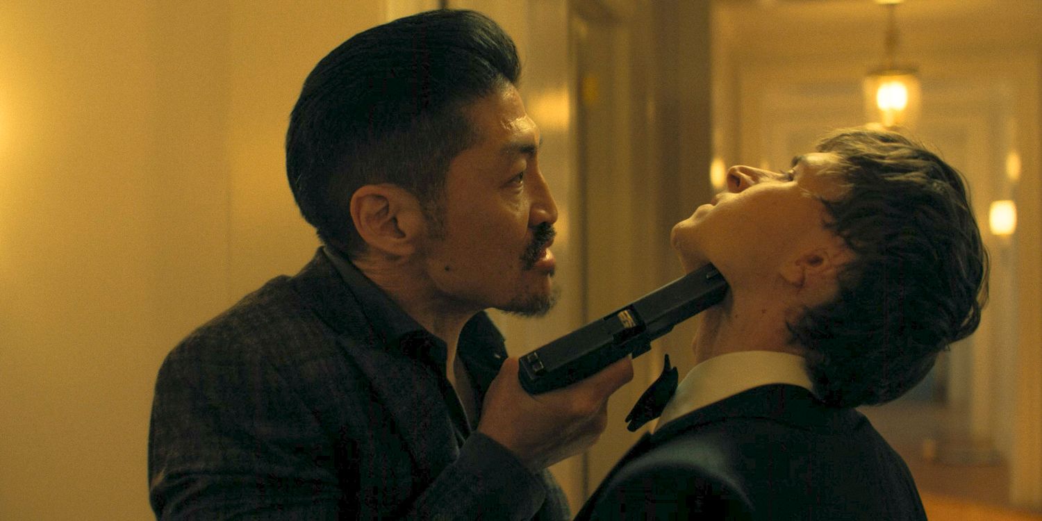 Quinn (Brian Tee) threatening Richard Beck (Johnny Berchtold) with a gun to his neck in Reacher Season 3 Ep 8