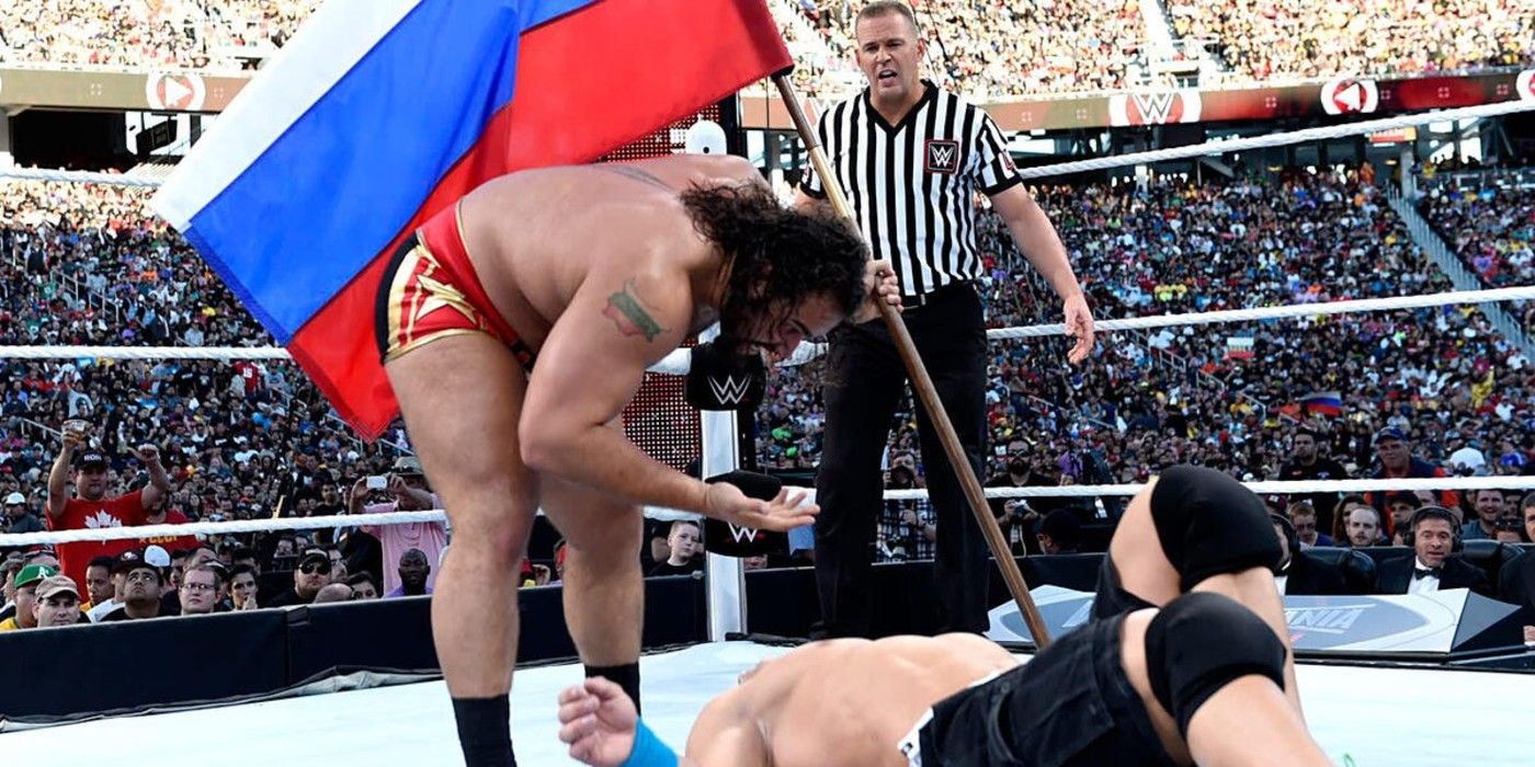 Rusev attempts a Five Knuckle Shuffle You Can&rsquo;t See Me taunt on John Cena while holding the Russian Flag at WWE WrestleMania 31