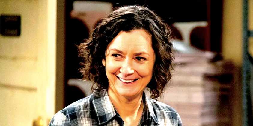 Sara Gilbert's Darlene smiles in The Conners