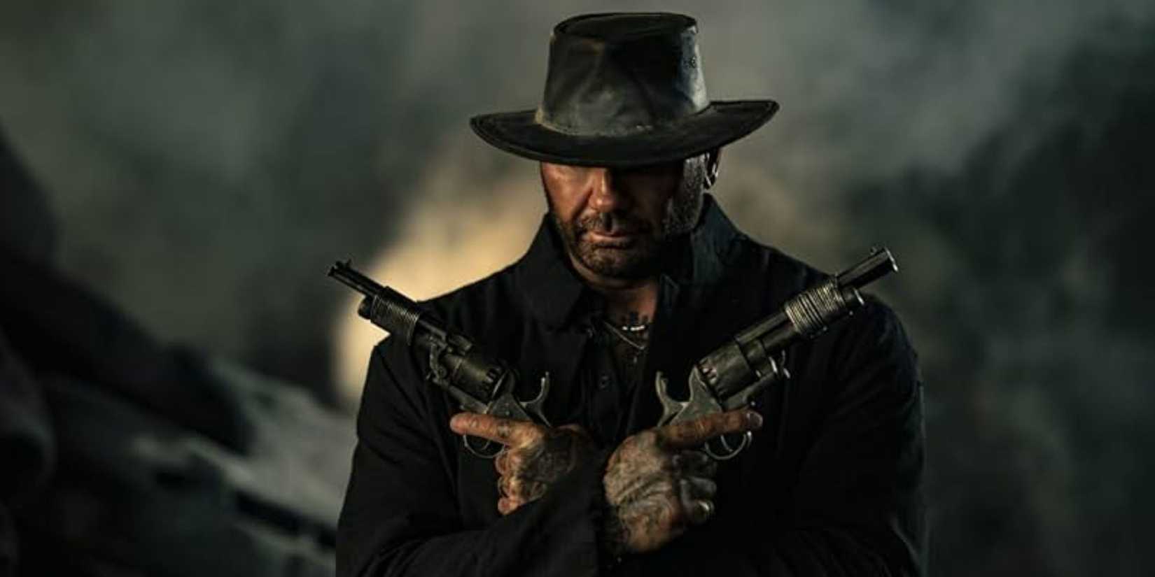 Dave Bautista holding a pair of pistols in In the Lost Lands