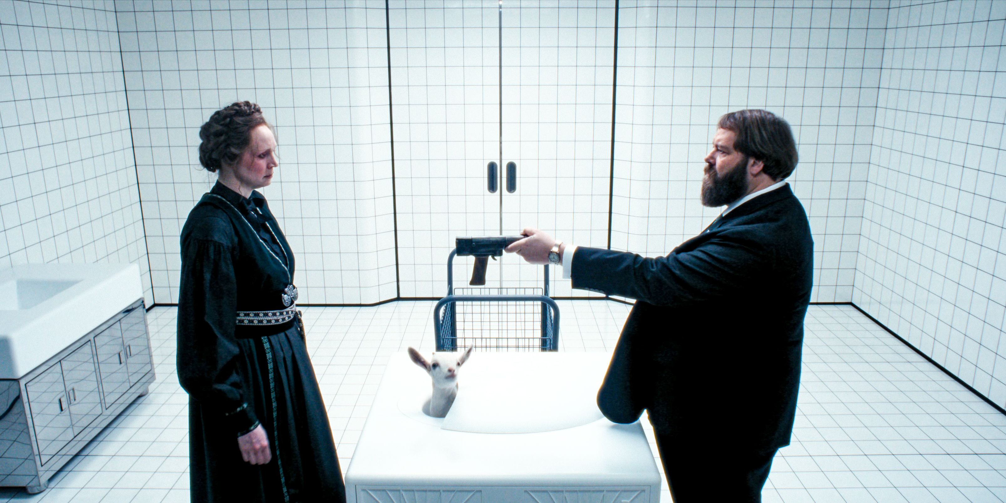 Mr. Drummond (Ólafur Darri Ólafsson) hands Lorne (Gwendoline Christie) a gun to kill a baby goat in Severance Season 2 Ep 10