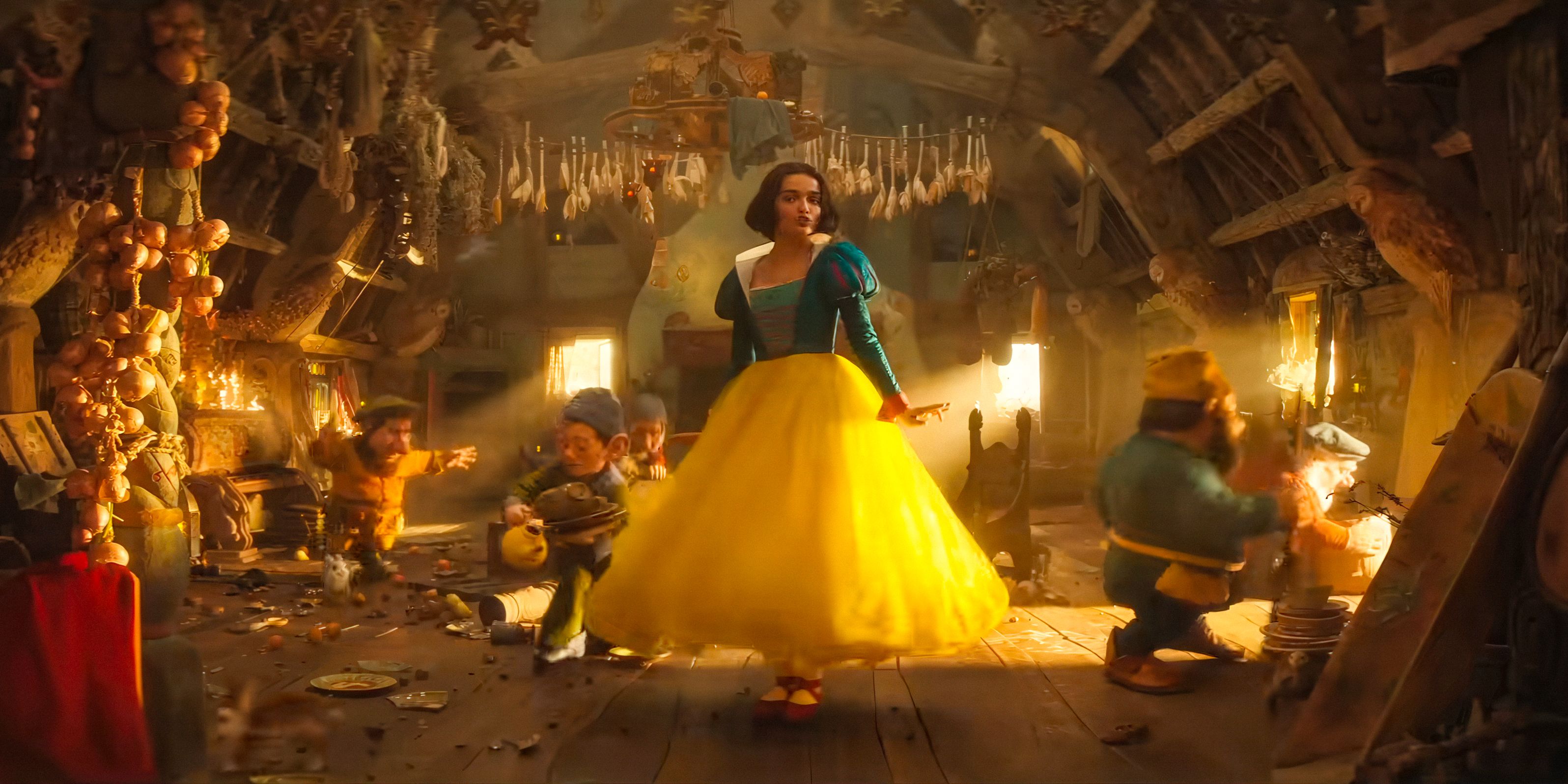 Snow White (Rachel Zegler) dances with the seven dwarves in Snow White (2025)