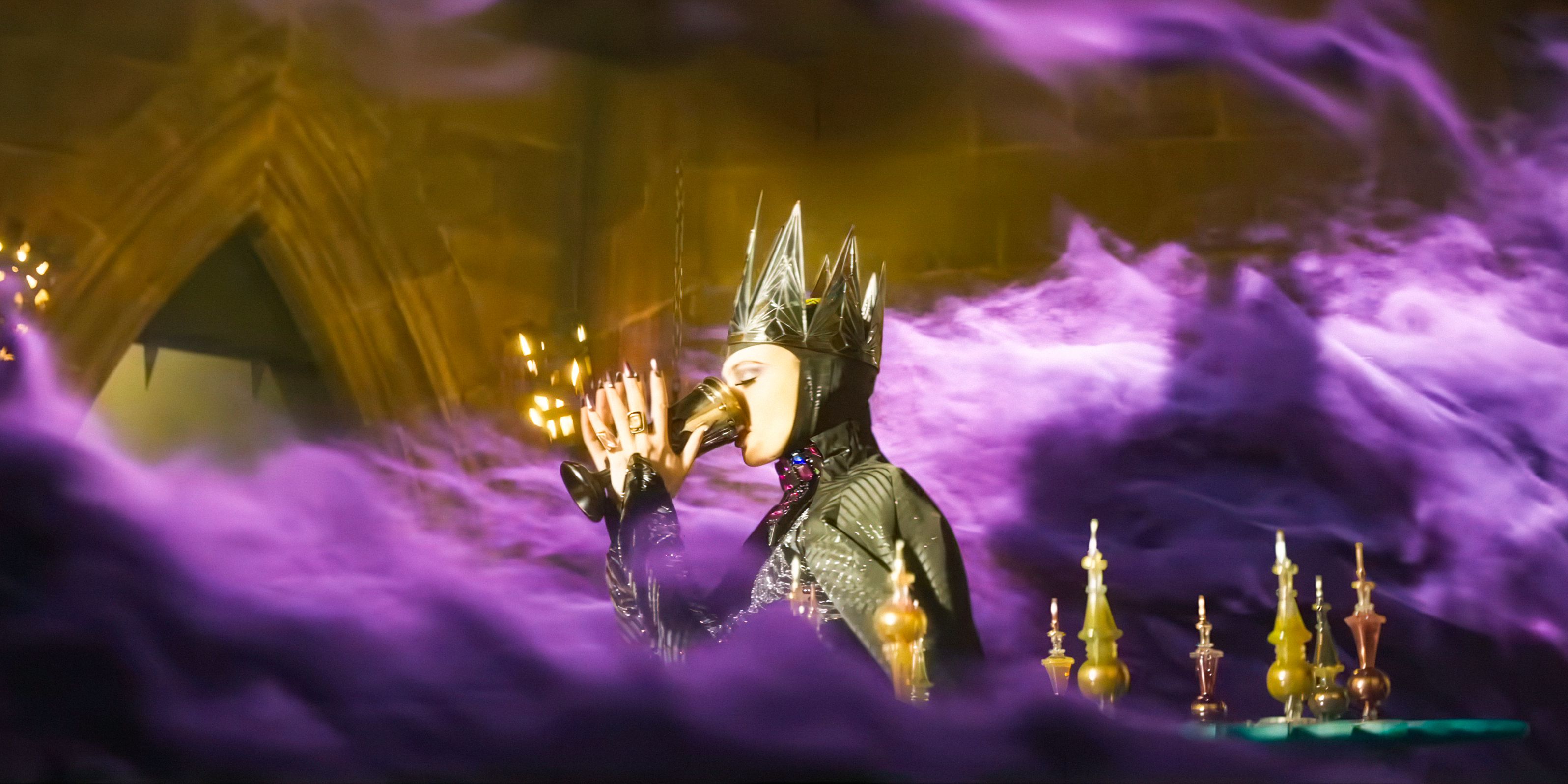 Evil Queen (Gal Gadot) drinking from a goblet surrounded by purple smoke in Snow White (2025)