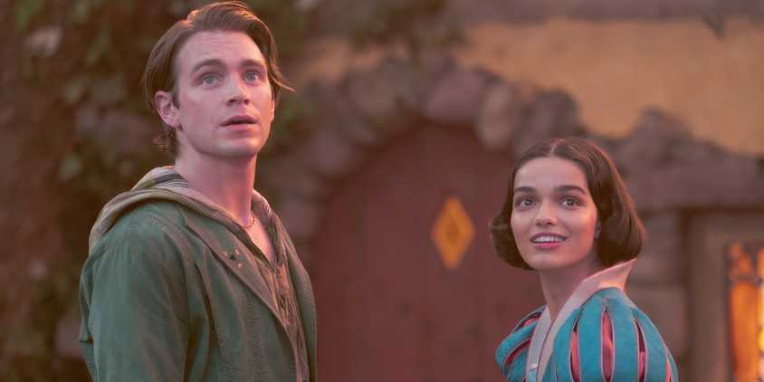 Snow White and Jonathan hold hands in front of the cottage in Snow White 2025