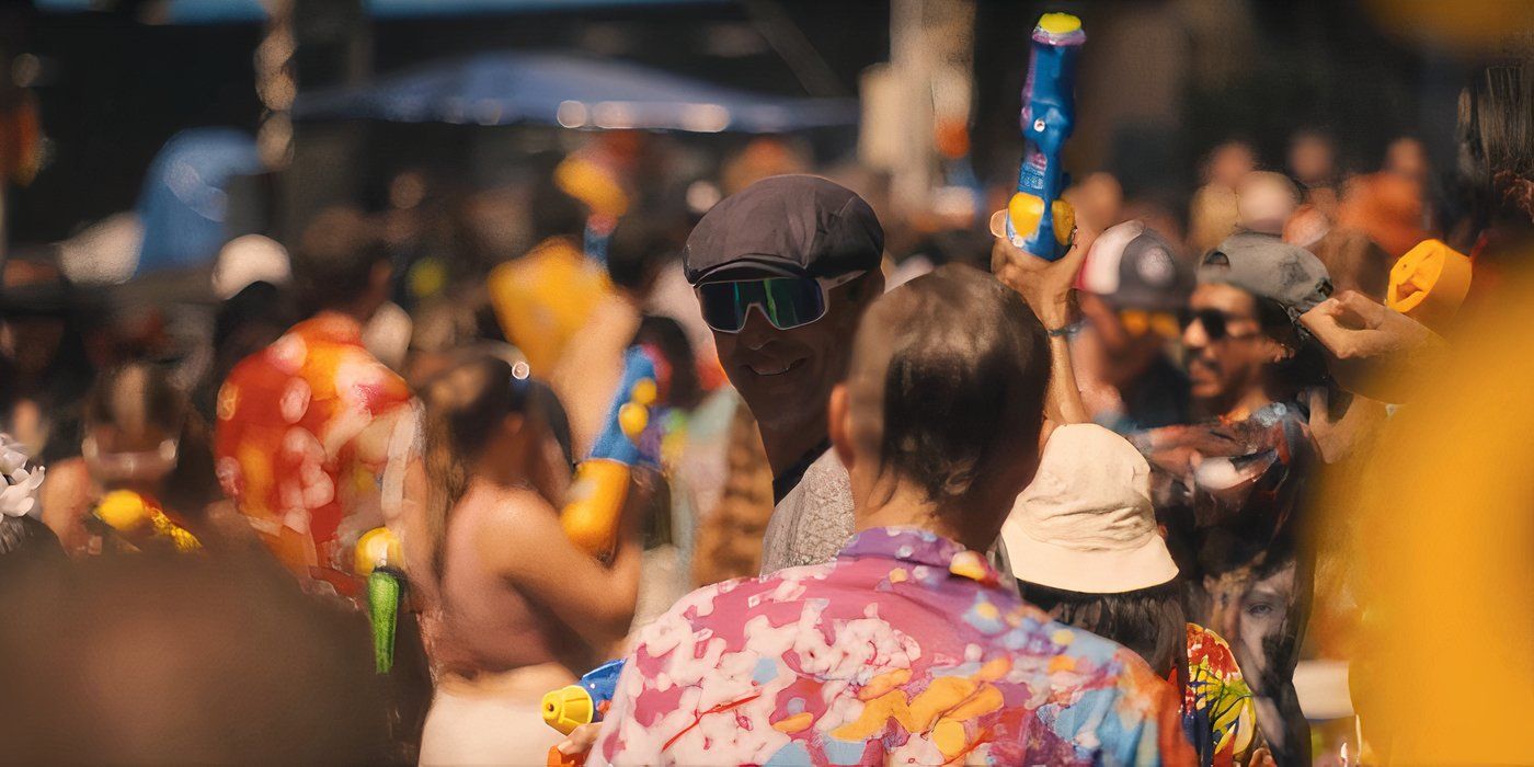 The streets of Thailand filled with people having a Songkran Water Fight in The White Lotus season 3, episode 4