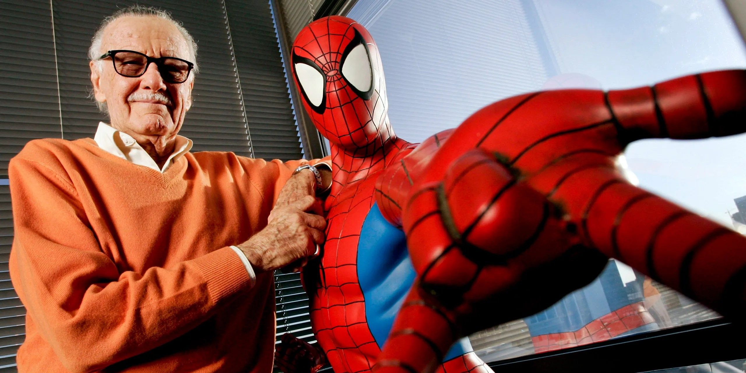 Stan Lee and Spider-Man stand together.