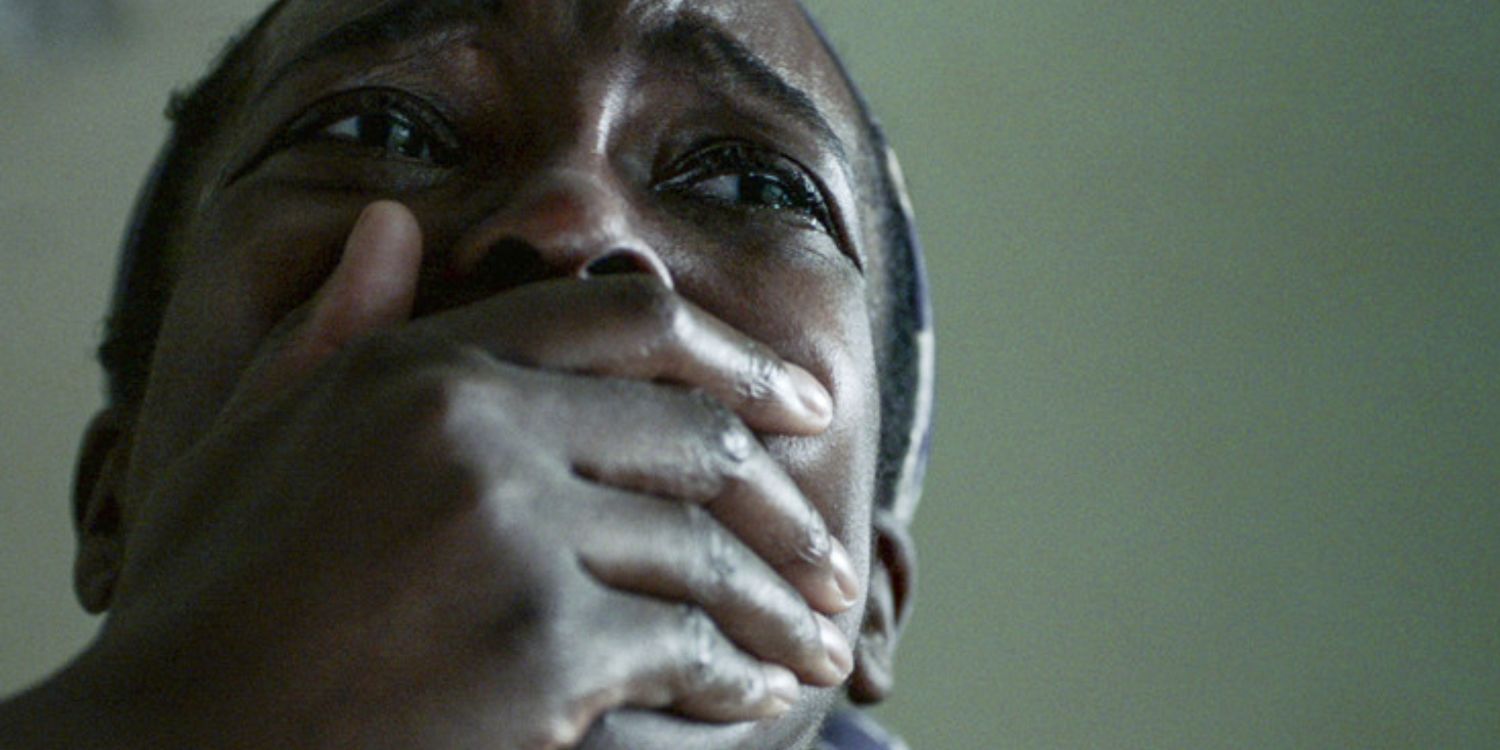 A woman with a hand over her mouth in His House