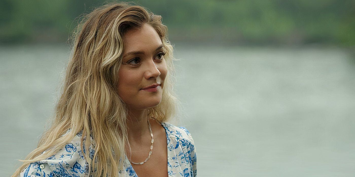 Lola smirks while standing near the lake in Sullivan&rsquo;s Crossing