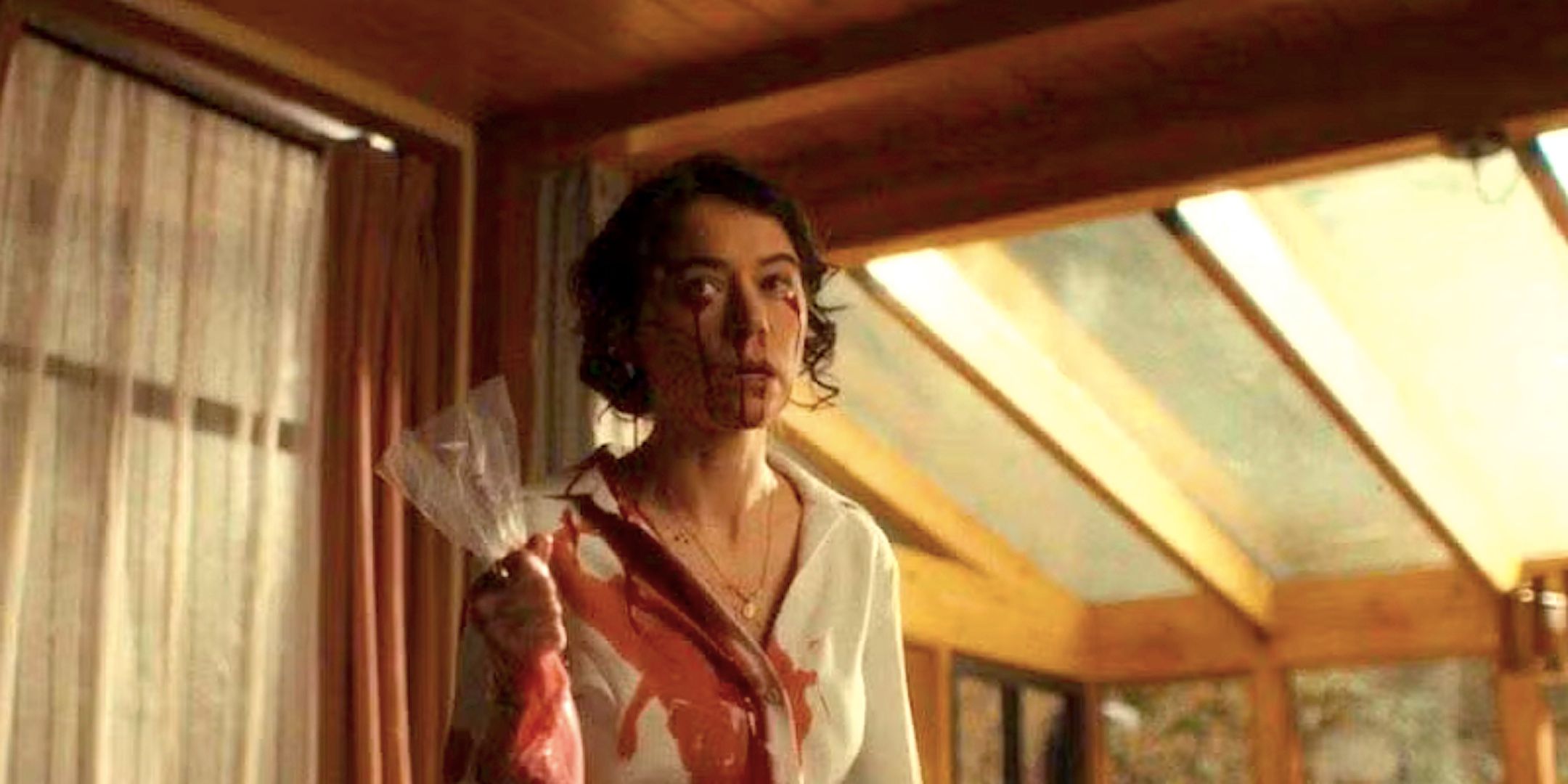 Tatiana Maslany's Lois holds a piping bag as blood pours from her eyes in The Monkey trailer