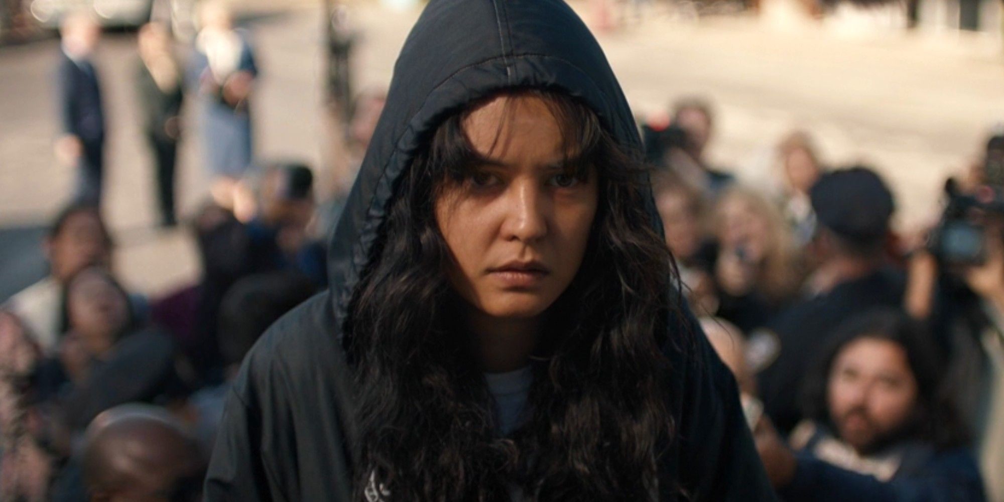 Teen Lottie wearing a hood getting onto a plane after being rescued in Yellowjackets season 2 episode 1