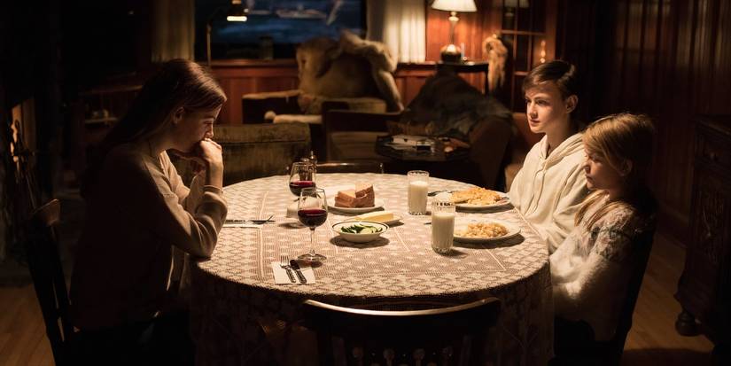 The Family Sat Around The Table In The 2019 horror movie The Lodge