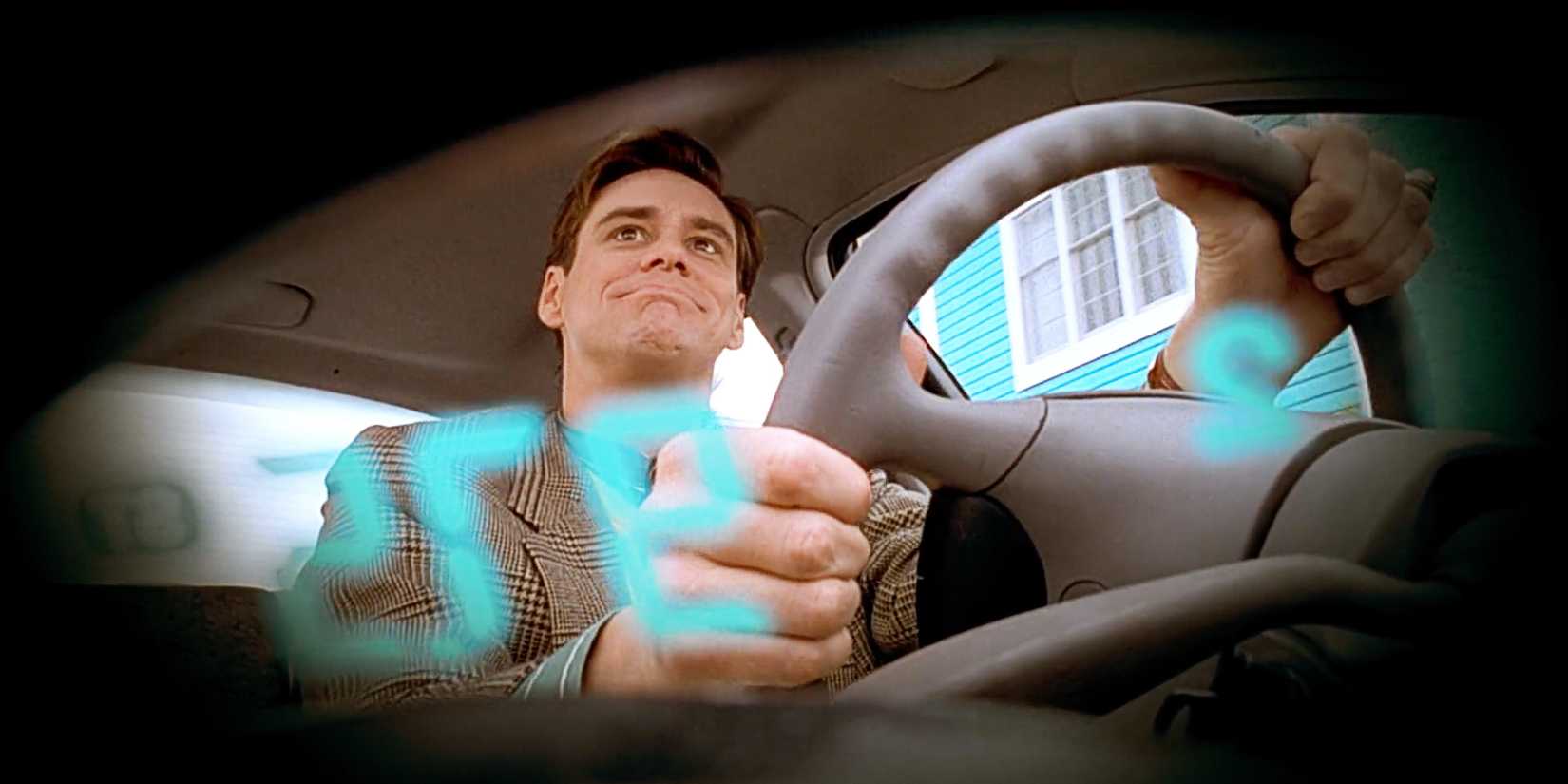 Jim Carrey as Truman Burbank driving his car in The Truman Show.