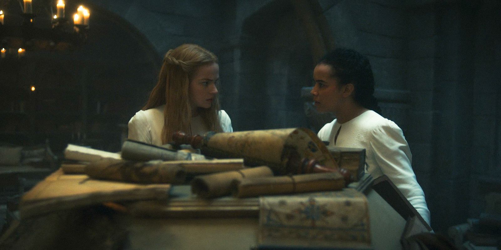 Elayne Trakand (Ceara Coveney) and Nynaeve al&rsquo;Meara (Zoë Robins) in a library in The Wheel of Time Season 3 Ep 3