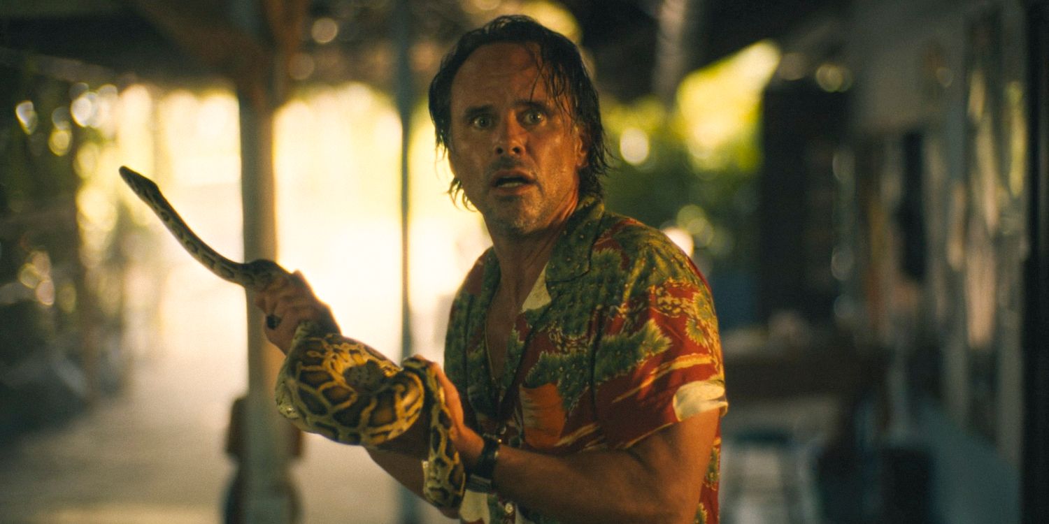 Rick Hatchett (Walton Goggins) looking insane holding a snake in The White Lotus Season 3 Ep 3