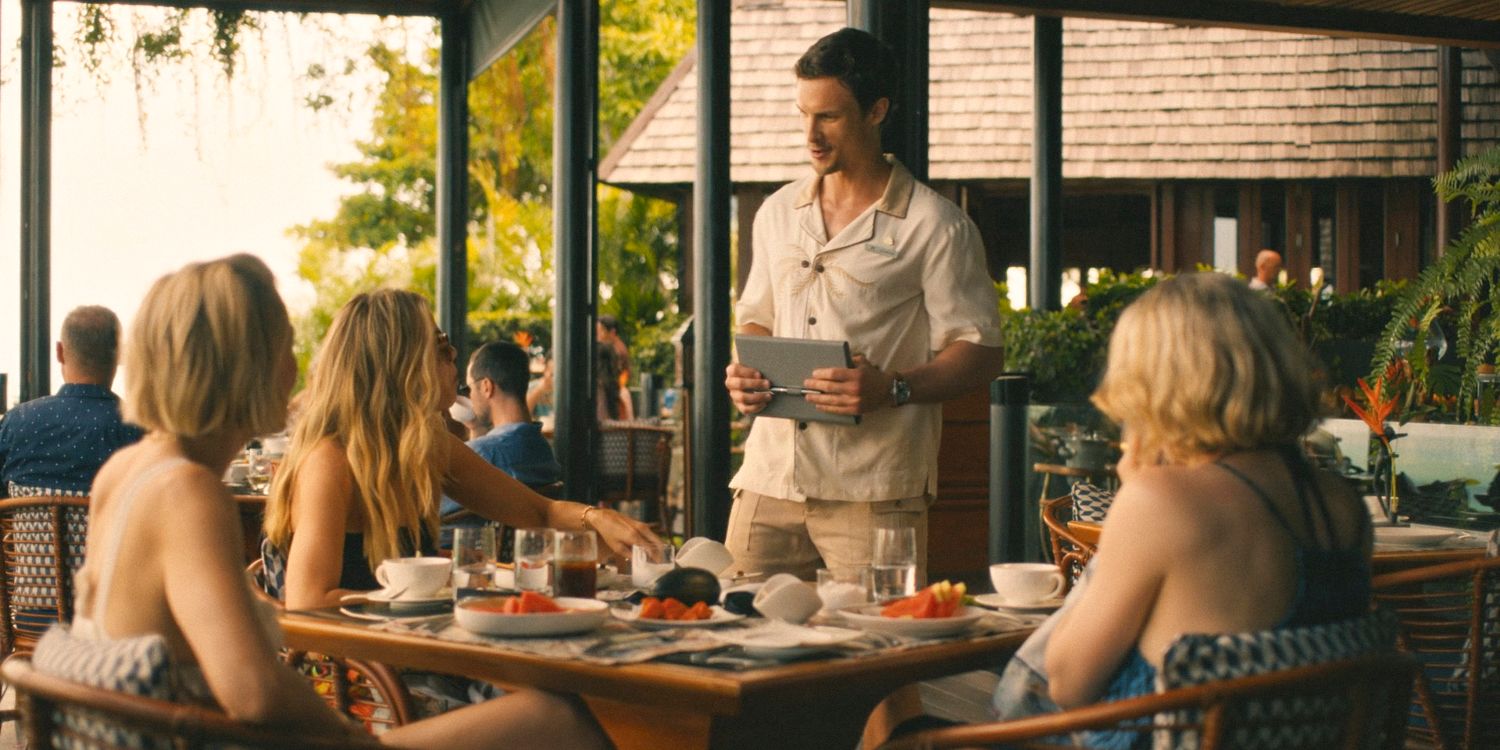 Valentin greets Jaclyn, Kate, and Laurie while they have breakfast in The White Lotus Season 3 Ep 3
