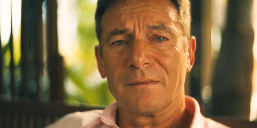 Close-up of Timothy (Jason Isaacs) looking distressed in The White Lotus Season 3 Episode 6