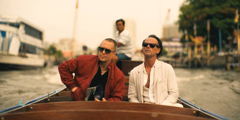 Frank (Sam Rockwell) and Rick (Walton Goggins) on a boat heading to Sritala's house in The White Lotus Season 3 Episode 6