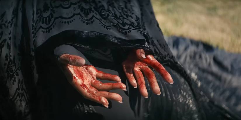 The Woman's hands have blood on them in The Woman in the Yard