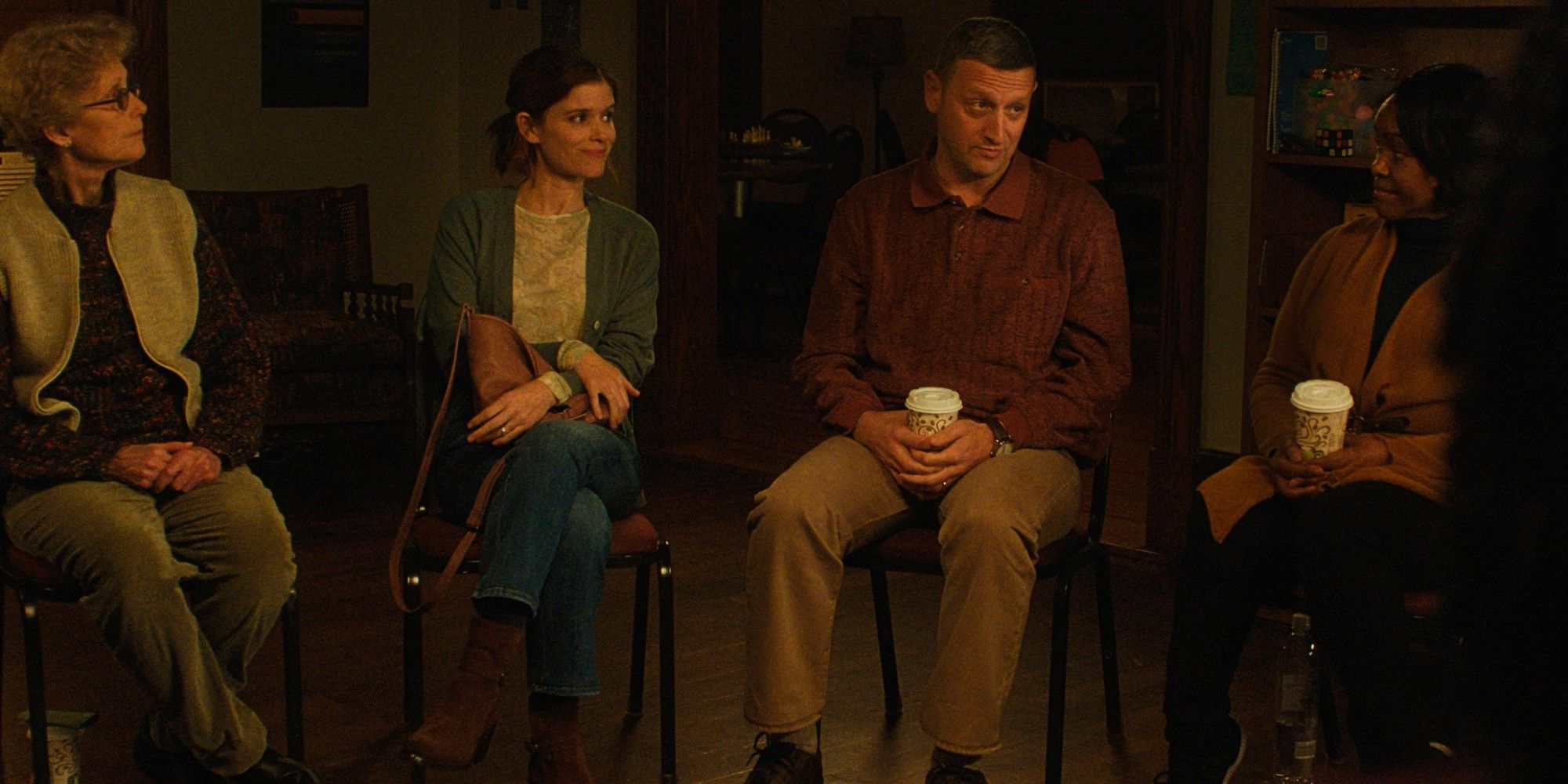 Tim Robinson and Kate Mara sit in a circle in a cancer support group in Friendship
