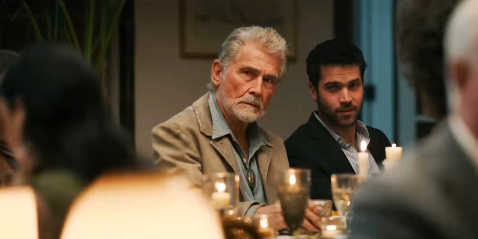 Two men look gravely from the dinner table in Ransom Canyon's trailer